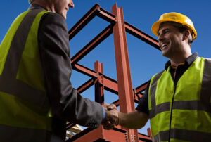 Contractors negotiate insurance pricing at construction or roofing site